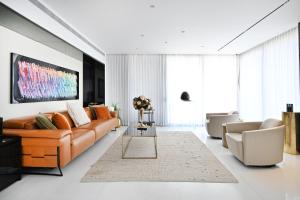 a living room with a couch and a table at Luxurious 3BR Penthouse with Jacuzzi by HolyGuest in Tel Aviv