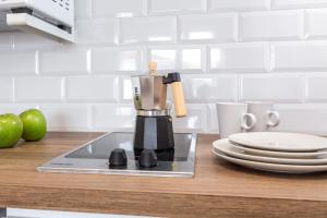 a kitchen counter with a coffee maker on a counter top at Estudio Bianca in L'Escala
