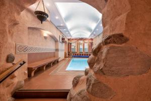 a home with a pool in a rock wall at Relais & Châteaux Stikliai Hotel in Vilnius