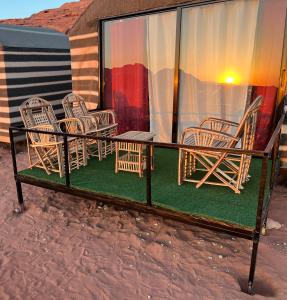 a group of chairs sitting on top of a balcony at Wadi Rum Desert Goals camp in Wadi Rum