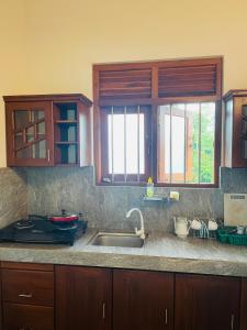 a kitchen with a sink and a counter top at Royal Resort in Weligama