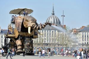 a statue of an elephant with people on top of it at La Grande Madeleine in Nantes