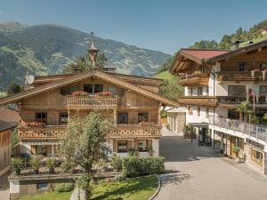 an apartment building in the mountains with a balcony at Leitnerhof in Ramsau im Zillertal