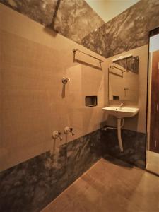 a bathroom with a sink and a mirror at HOTEL ELITE in Rāmeswaram