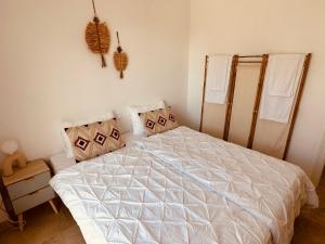 a bedroom with a large bed with white sheets and pillows at Modernes Ferienappartement (9-1F) in Manilva