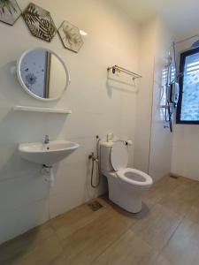 a bathroom with a sink and a toilet and a mirror at KLIA AIRPORT HOMESTAY 3 in Sepang