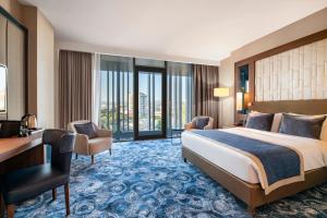 a hotel room with a bed and a desk at Tbilisi Philharmonic Hotel by Mercure in Tbilisi City +92 photos