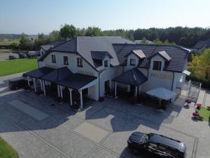 a house with a car parked in front of it at Zajazd Arkadia in Siemiatycze