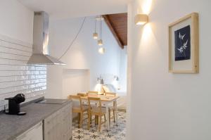 a kitchen with a table and a dining room at Torre de la Yerba in Cáceres