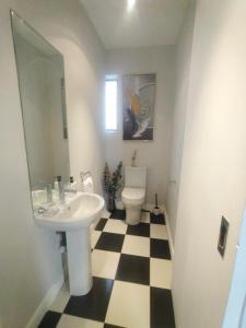 La salle de bains est pourvue d'un lavabo et de toilettes. dans l'établissement @Derricks Luxury Apartments, à Johannesbourg