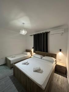 a bedroom with two beds and a window at Rus Villa in Berat