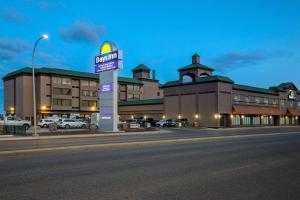 a building with a hotel sign in front of a street at Days Inn by Wyndham Calgary South in Calgary