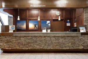 a restaurant counter with a picture of a man in the window at Days Inn by Wyndham Calgary South in Calgary