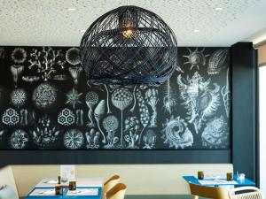 un comedor con una pared en blanco y negro en ibis Thalassa Le Touquet, en Le Touquet-Paris-Plage