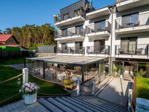 an external view of a building with a patio at Natura Mierzei 30 in Krynica Morska