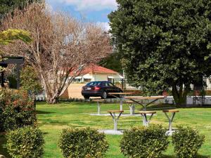 a park with a picnic table and a car in the background at ibis Styles Albany in Albany