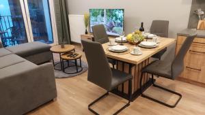 a living room with a dining room table and chairs at Apartament Kallisto in Bydgoszcz