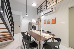 a dining room with a wooden table and chairs at Arte Cheras by Minsu in Kuala Lumpur