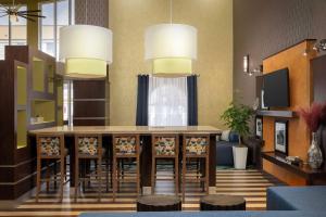 vestíbulo con mesa, sillas y TV en Hampton Inn & Suites Lake City, en Lake City