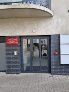 an entrance to a building with a revolving door at Apartament Sky in Leszno