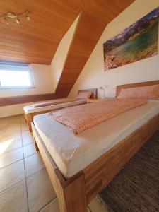 a bedroom with two beds and a window at Ferienwohnung in Rheinstetten