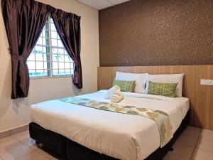 um quarto com uma cama grande e uma janela em SCC Gateway Chinatown Hotel em Kuala Lumpur