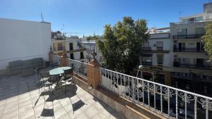 un balcone con tavolo e sedie su un edificio di Adriano by Global a Siviglia