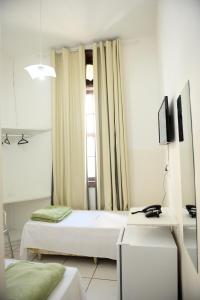 A bed or beds in a room at Grande Hotel Renascença