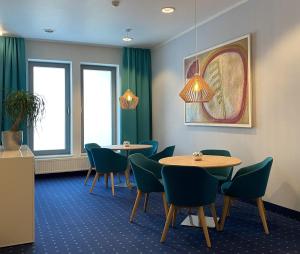 a waiting room with two tables and chairs at Hotel Stadthafen Stade in Stade +36 photos