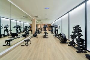 a gym with treadmills and exercise equipment in a building at Eurostars Oasis Marbella in Marbella