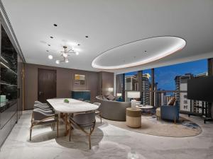 a living room with a table and chairs at Doubletree By Hilton Nanning Wuxiang in Nanning