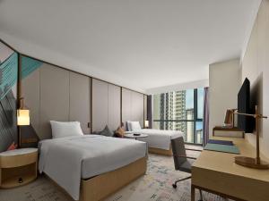 Postel nebo postele na pokoji v ubytování Doubletree By Hilton Nanning Wuxiang