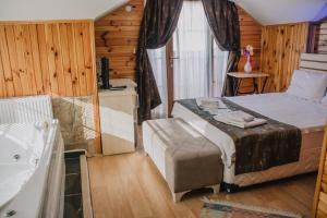 Un dormitorio con una cama y una bañera en una habitación. en Ağva Ayışığı Otel, en Agva 38 fotos más