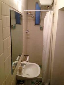 a bathroom with a sink and a shower with a mirror at Casina Roma, 2 min to Piazza Navona in Rome