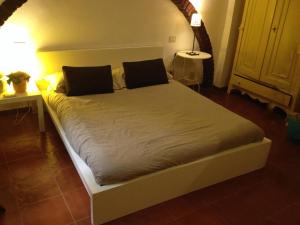 a bed with two pillows on it in a room at Casina Roma, 2 min to Piazza Navona in Rome
