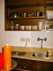 a kitchen counter with a sink and a candle at Casina Roma, 2 min to Piazza Navona in Rome