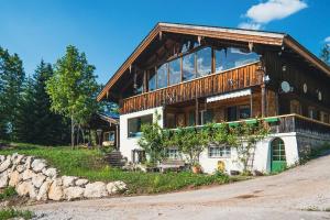 une grande maison avec un toit en bois dans l'établissement großes Berg-Chalet in der Natur, à Bayrischzell