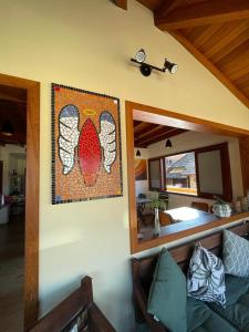 a living room with a couch and a picture on the wall at Pousada Anjo da Guarda in Guarda do Embaú