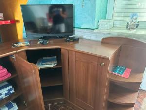 a television sitting on top of a wooden cabinet at Villa Kolorina in Dubrovnik