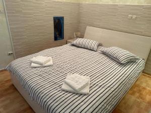 a bedroom with a bed with two pillows on it at Villa Kolorina in Dubrovnik