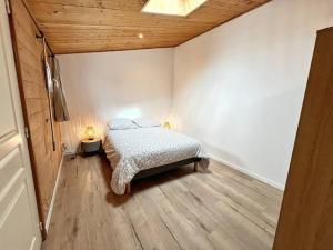 a bedroom with a bed and a wooden ceiling at L'évasion - Terrasse privée in La Rochelle