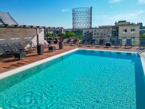 a swimming pool on the roof of a building at H10 Roma Città in Rome