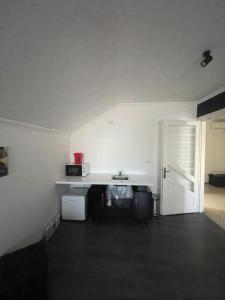 a white room with a sink and a door at Sara’S Apartament in Suceava