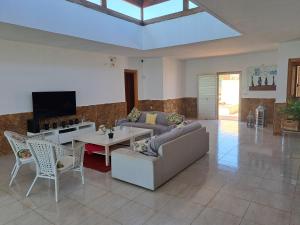 a living room with a couch and a table at VILLA PARADISE in La Guirra