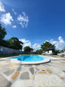 a large swimming pool with a blue at 971B - La Villa ROUYO, villa créole accessible PMR in Le Moule
