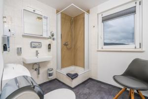 a bathroom with a shower and a sink at Pension Bayerwald in Bodenmais