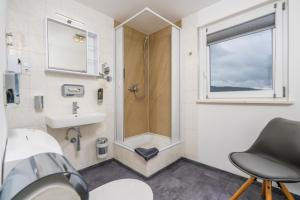 a bathroom with a shower and a sink at Pension Bayerwald mit Ferienwohnung in Bodenmais +65 photos
