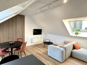 a living room with a couch and a table at Stylisches Apartment in zentraler Lage - mit Klima in Karlsruhe