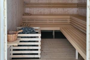 a sauna with wooden floors and wooden stairs at PortaMare Marina Dziwnów Apartment by Renters Prestige in Dziwnów
