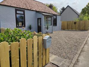 a fence in front of a house with a mailbox at Westview in Buckie